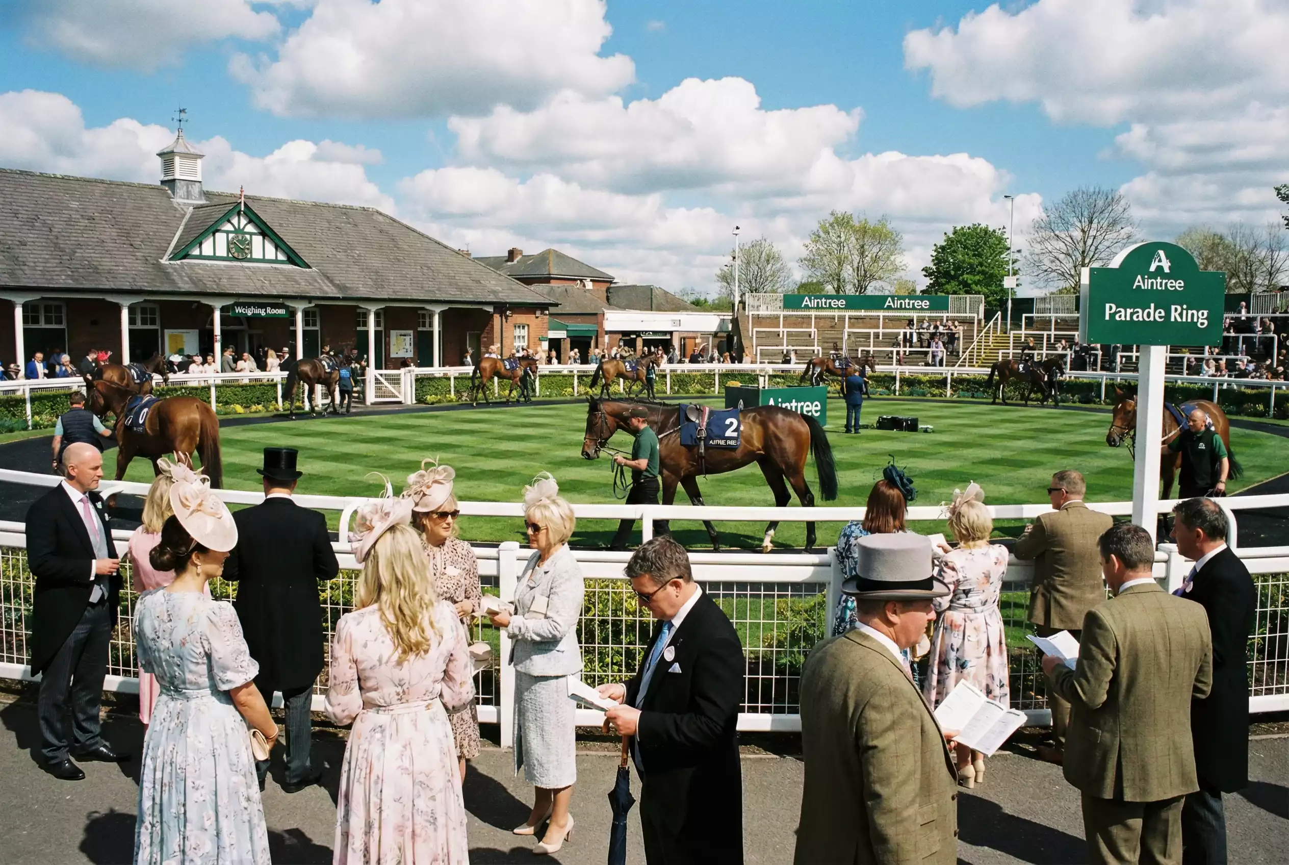 Aintree Festival Ladies Day with racegoers and horses on track