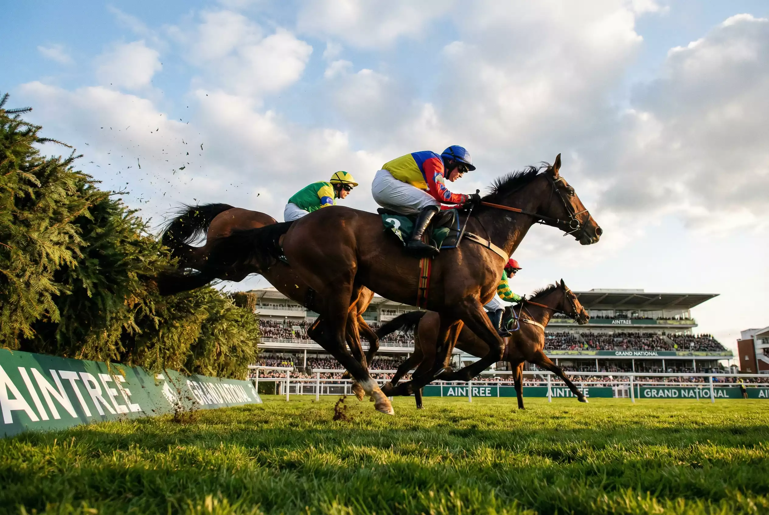 Horses jumping famous fences at Aintree Grand National racecourse