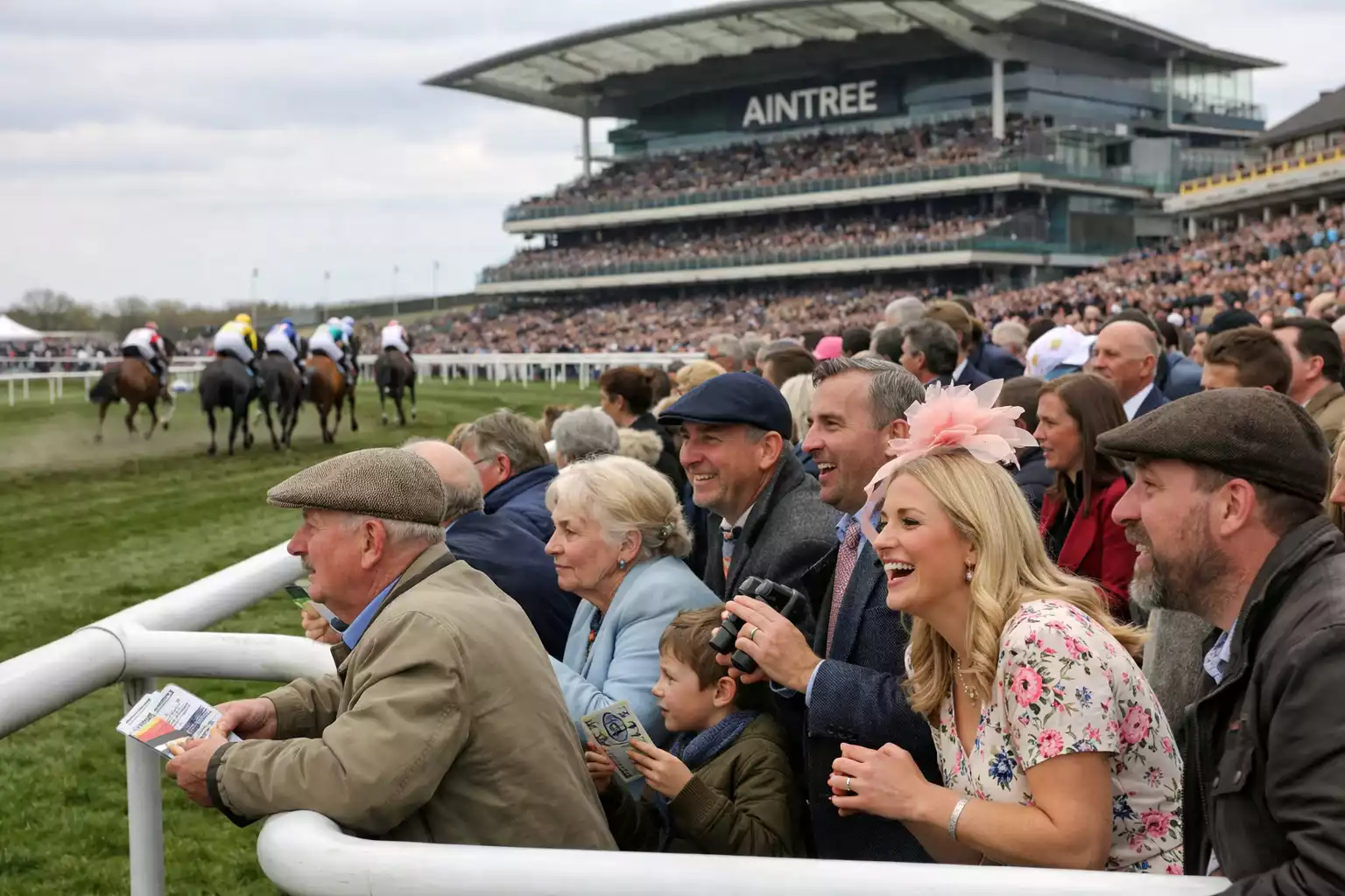 Crowds gathered at Aintree Festival watching Grand National race day